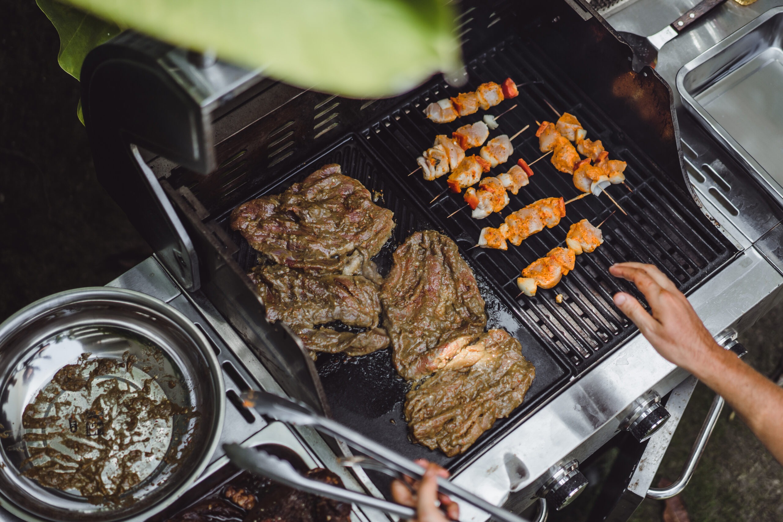 man tattoos makes barbecue grill meat outdoors 1 scaled