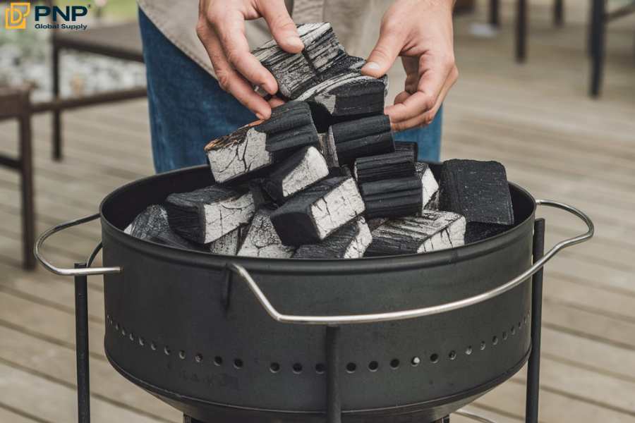 The first step in using a charcoal grill is laying some charcoal in the grill chimney