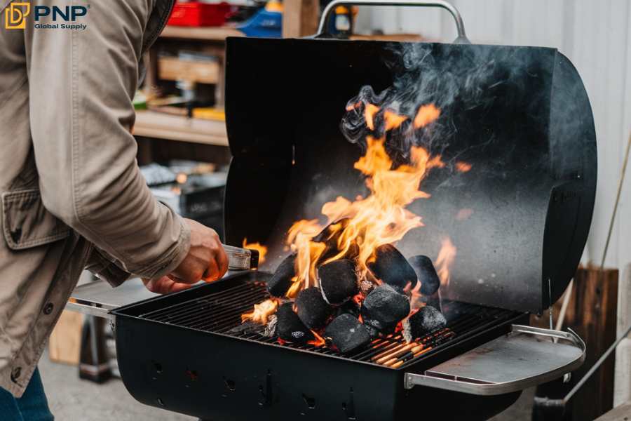 Ready your fire starter to burn the charcoal in the grill chimney