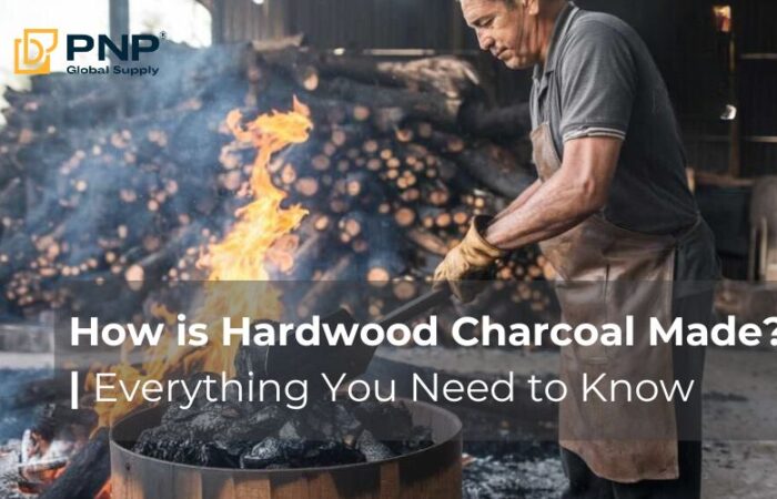 A worker stacking wood in a kiln to demonstrate the process of how charcoal is made.