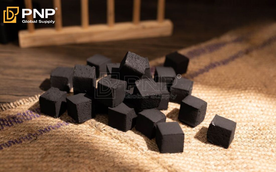 Charcoal briquettes inside a metal barbecue grill