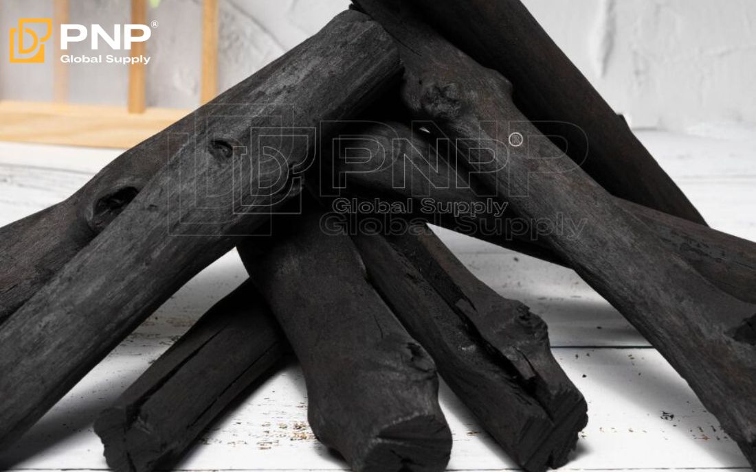 Charcoal briquettes arranged in a pyramid shape