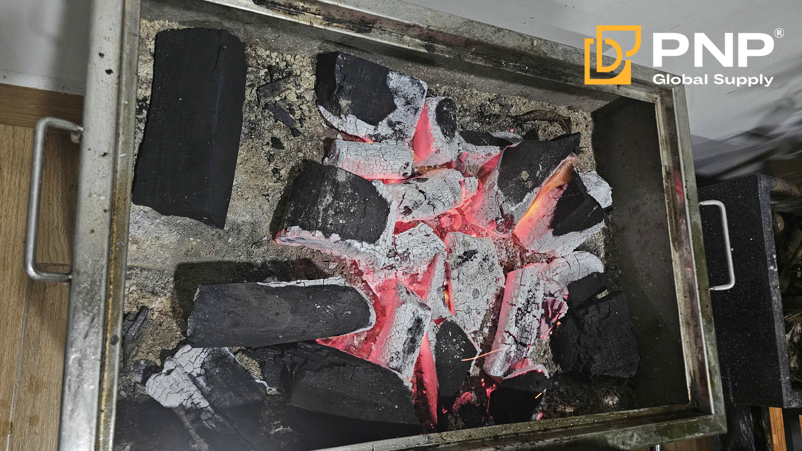 Preheat the charcoal until it glows red for perfect Peking Duck