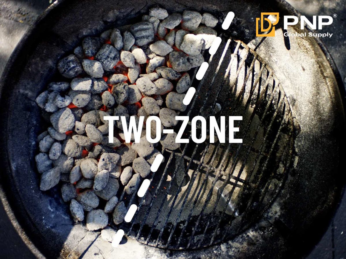 A two-zone charcoal arrangement provides direct and indirect cooking areas
